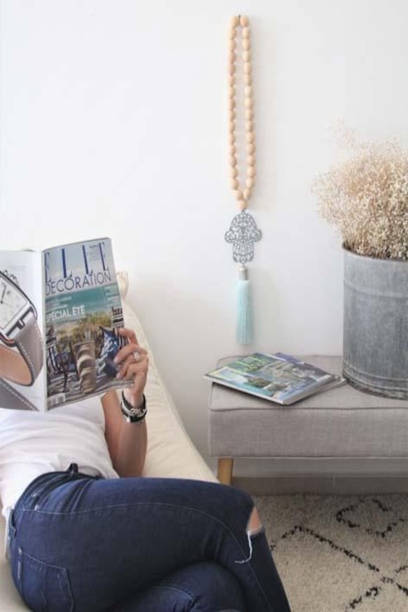 Decorative Hamsa wall hanging with wood bead accents, featuring intricate patterns and a natural, rustic aesthetic, ideal for adding a touch of cultural charm and spiritual significance to your home decor