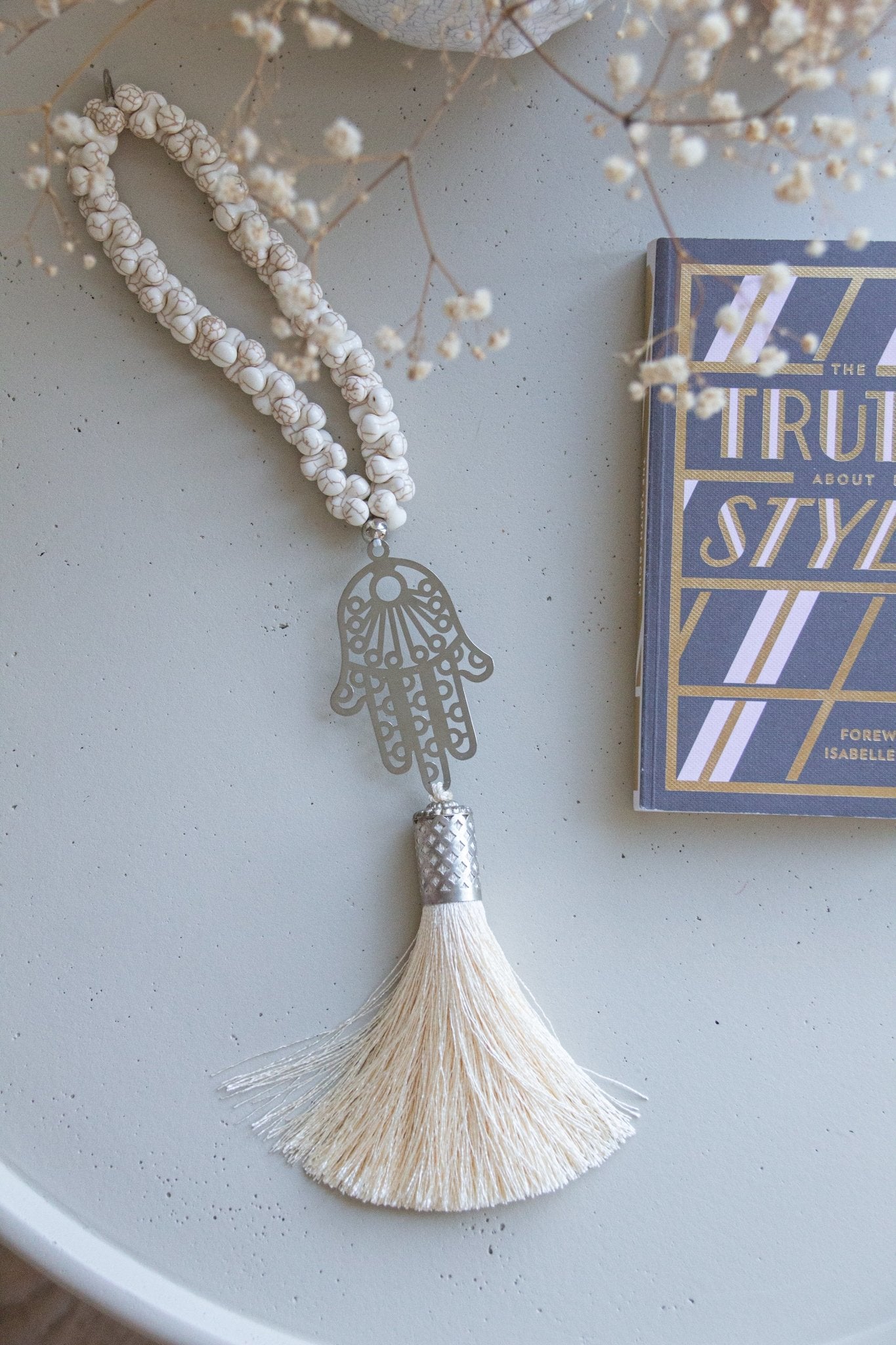 Silver-plated Hamsa hand wall hanging with cream Howlite stones and silk tassel. Modern bohemian protection charm against evil eye