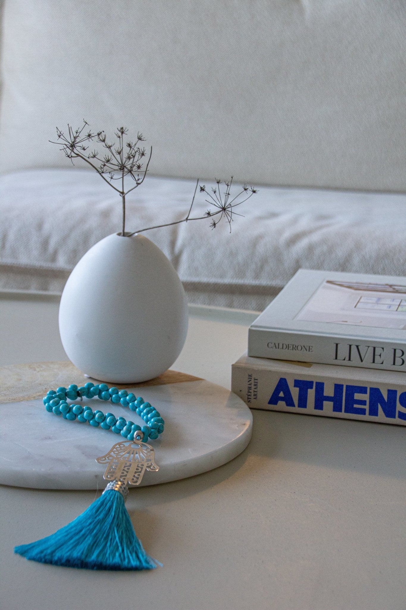 Silver-plated Hamsa hand wall hanging with turquoise Howlite stones and silk tassel. Modern bohemian protection charm against evil eye