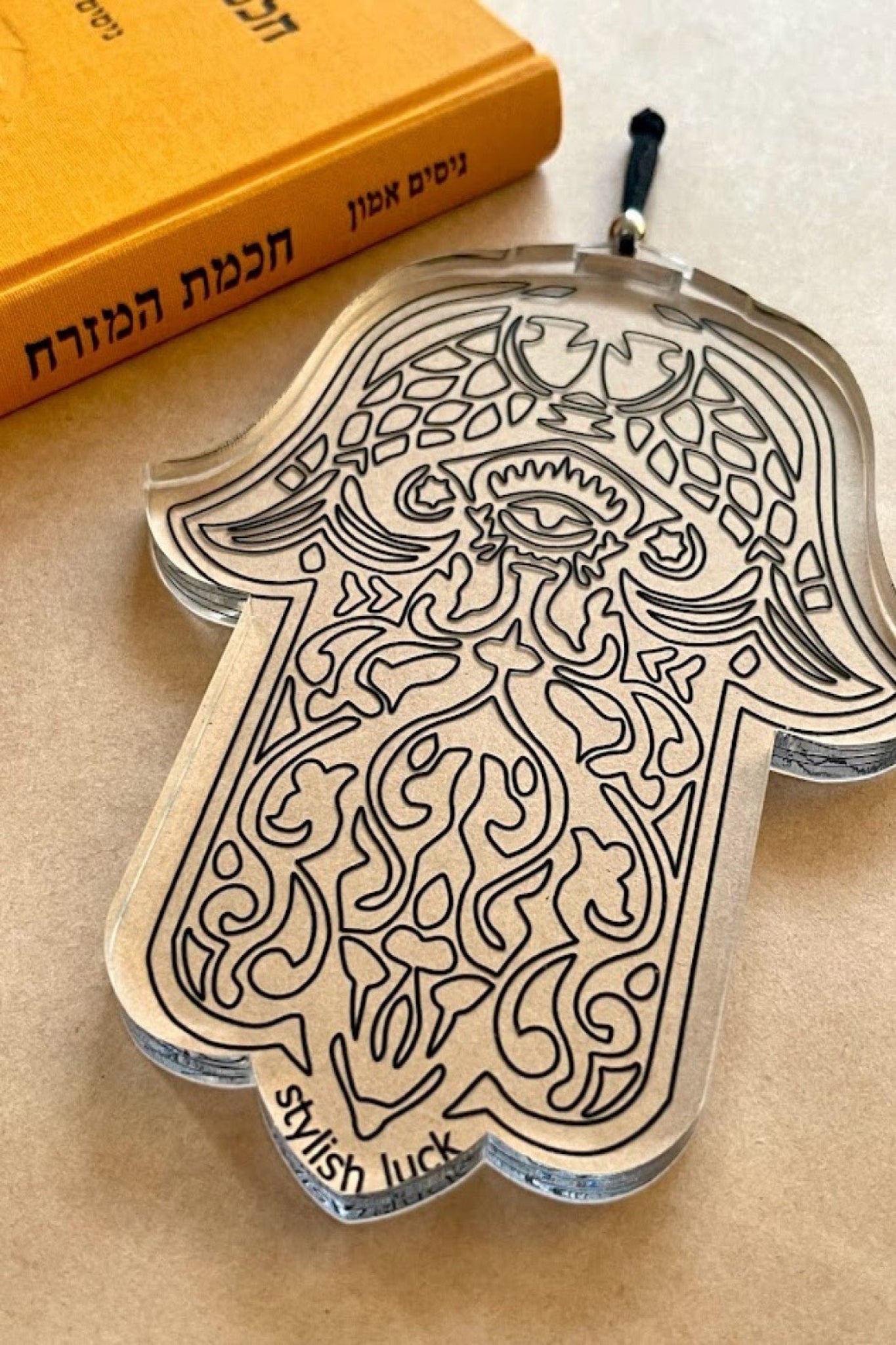 חמסה שקופה, חמסה מפרספקס, חמסה עם עין הרע, קישוט קיר חמסה, חמסה מעוצבת, קמע למזל טוב, חמסה מודרנית, חמסה לבית, חמסה ייחודית, חמסה להגנה, עיצוב רוחני לבית, חמסה אלגנטית, תכשיט קיר חמסה, חמסה חרוטה, קמעות ומזל.
Transparent Hamsa, acrylic Hamsa, engraved Hamsa, Evil Eye Hamsa, modern Hamsa decor, spiritual home decor, wall hanging Hamsa, lucky charm Hamsa, protection amulet, unique Hamsa design, acrylic wall decor, boho home accessory, positive energy charm, mystical home decor, elegant Hamsa ornament.stylish
