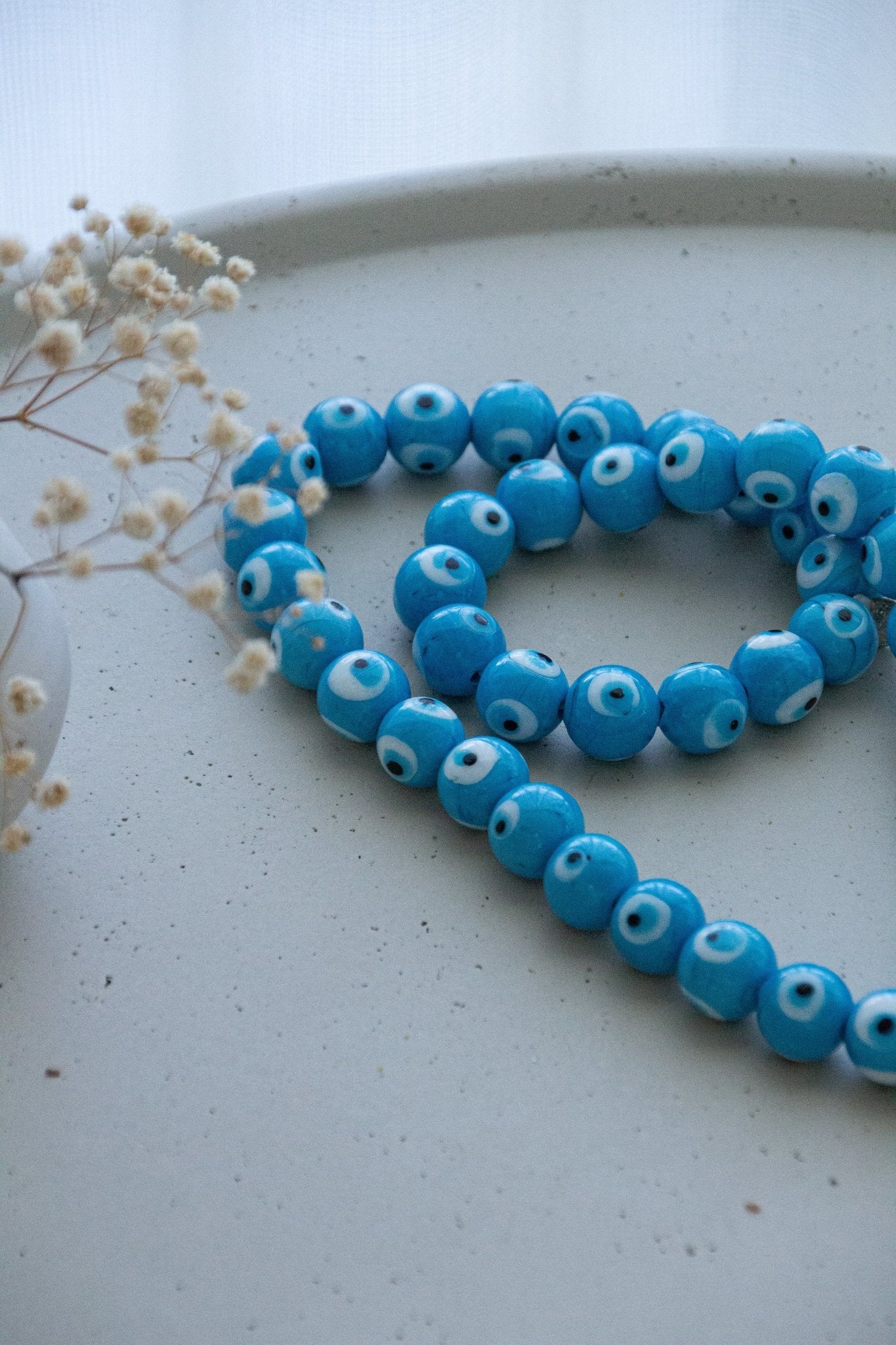 
Evil eye bead strand • Turquoise evil eye • Glass bead evil eye • Handmade evil eye • Misbaha beads • Modern prayer beads • Table decor evil eye • Boho home decor • Evil eye protection • Middle Eastern home decor • Housewarming gift • Meaningful gift • Stylish Luck • Made in Israel 
שרשרת עין הרע • חרוזי עין • קישוט שולחן • אובייקט עיצובי • חרוזי זכוכית בעבודת יד • מסבחה מודרנית • שמירה מעין הרע • עיצוב הבית • חפצי נוי • מתנה לחנוכת בית • מתנה משמעותית • סמלי מזל • Stylish Luck • מיוצר בישראל